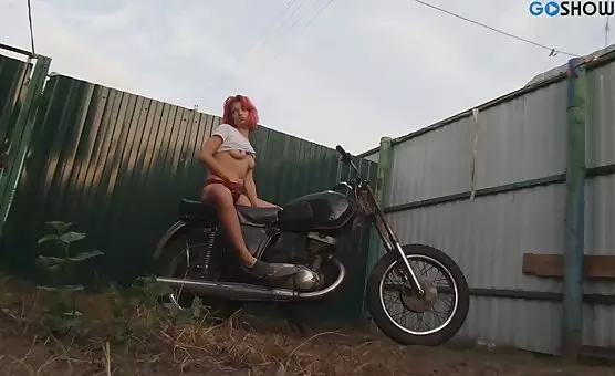 Seductive babe teasing atop motorbike